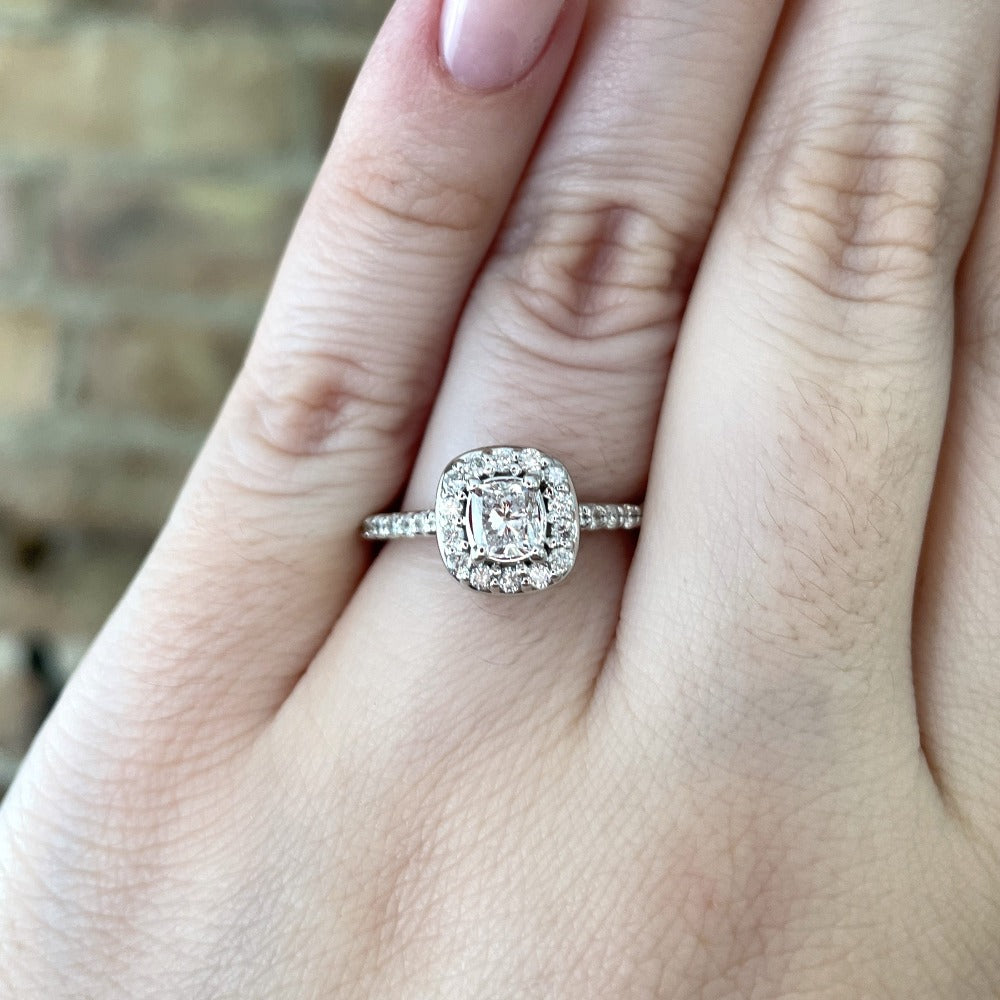 closer, more detailed view of 14kw halo style engagement ring on model