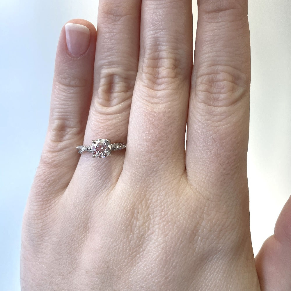 14kw round diamond engagement ring with twisted shank on model