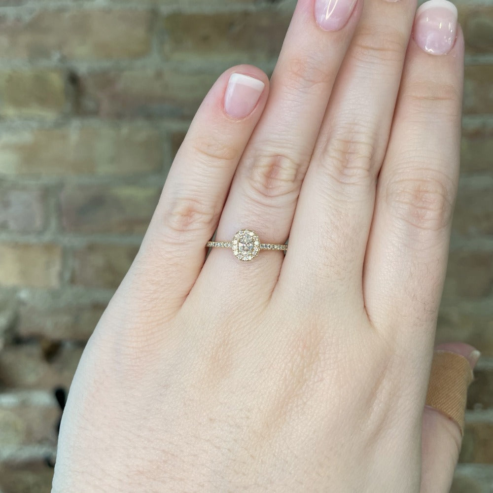 14ky oval halo style engagement ring on model