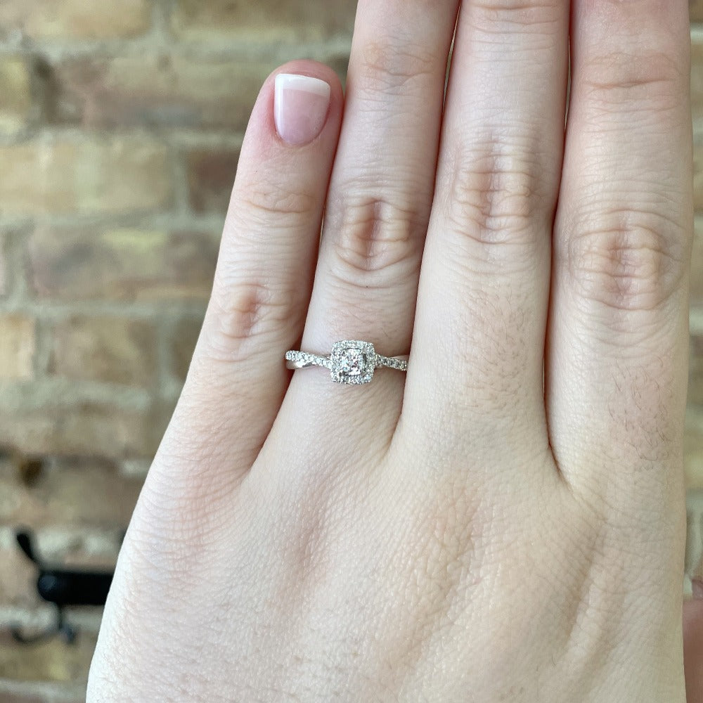 view of 14kw halo style engagement ring with twisted shank on model