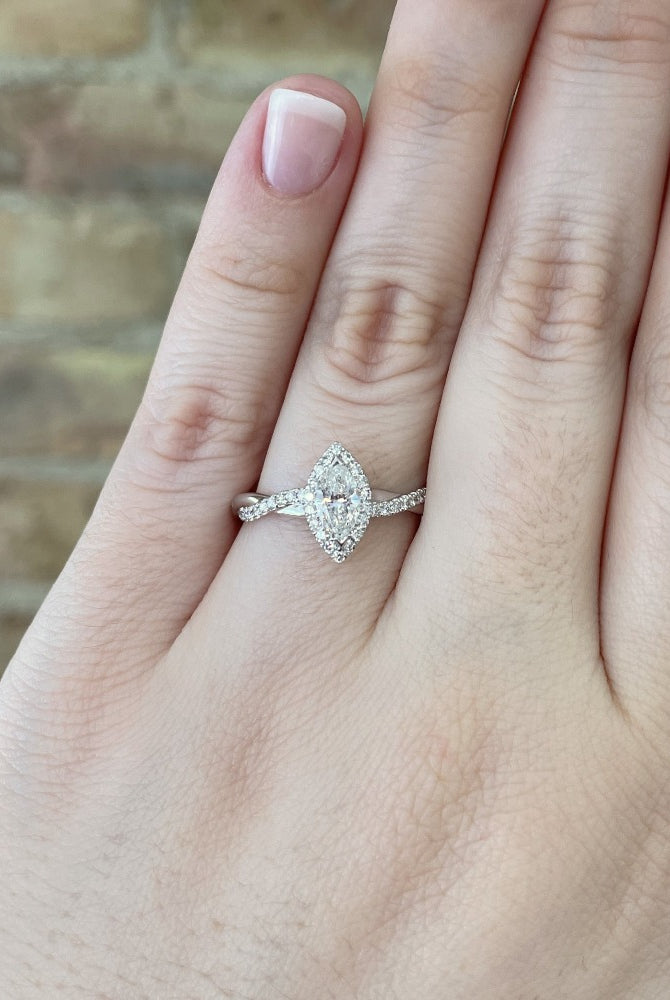 14kw marquise halo style engagement ring with criss cross shank on model