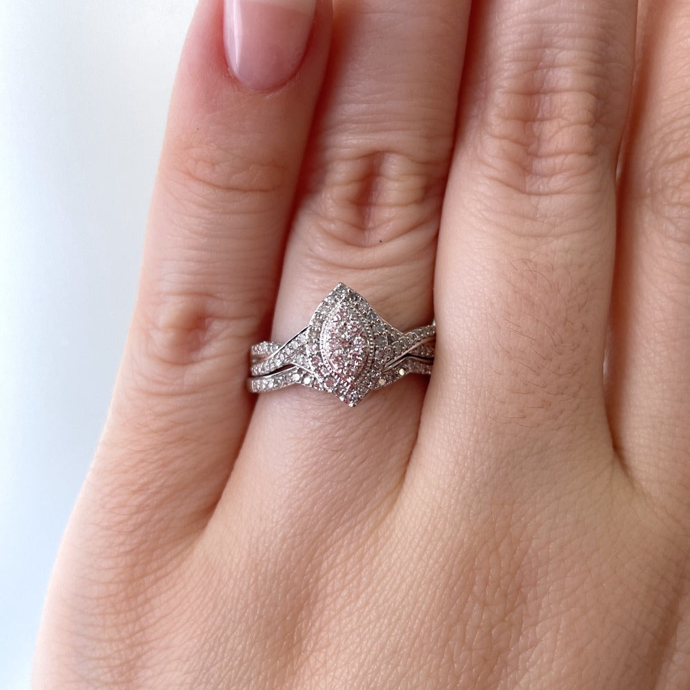 up close detail picture of wedding set on model's hand in natural light.