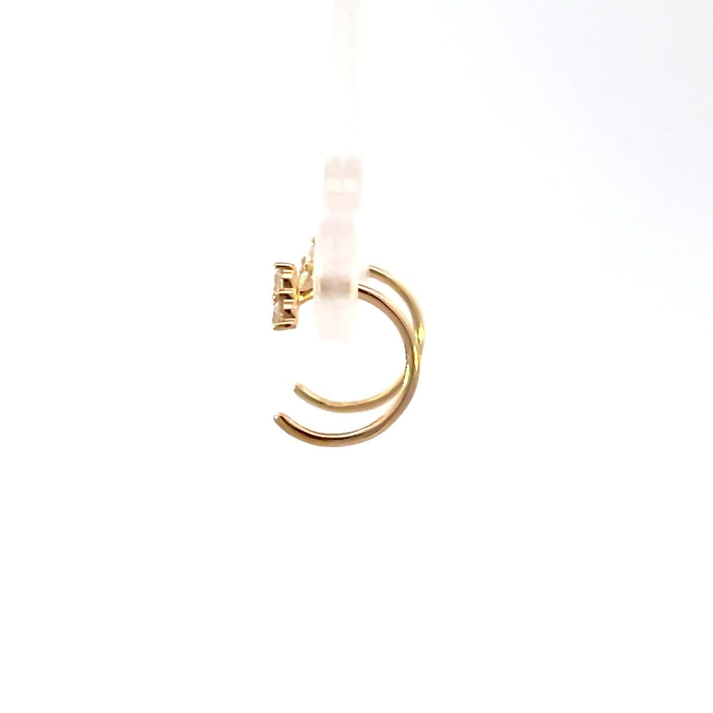 side profile view of 14ky tri-diamond huggle hoop earrings.