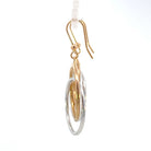 side view of 14k two-toned gold circle drop earrings with french wires