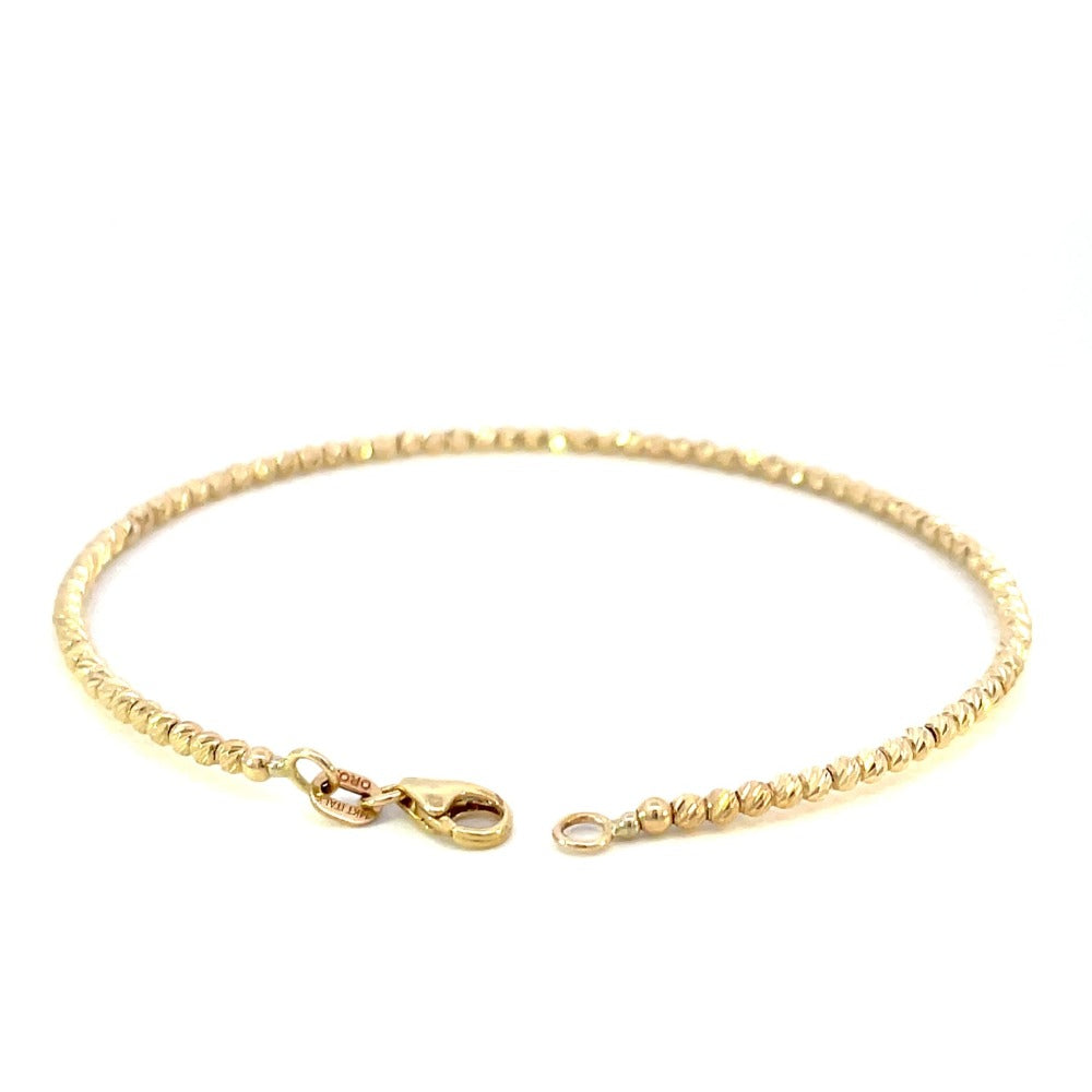 back view of 14ky gold bead cuff bracelet with diamond cutting on the beads. picture shows the lobster clasp and karat stamps