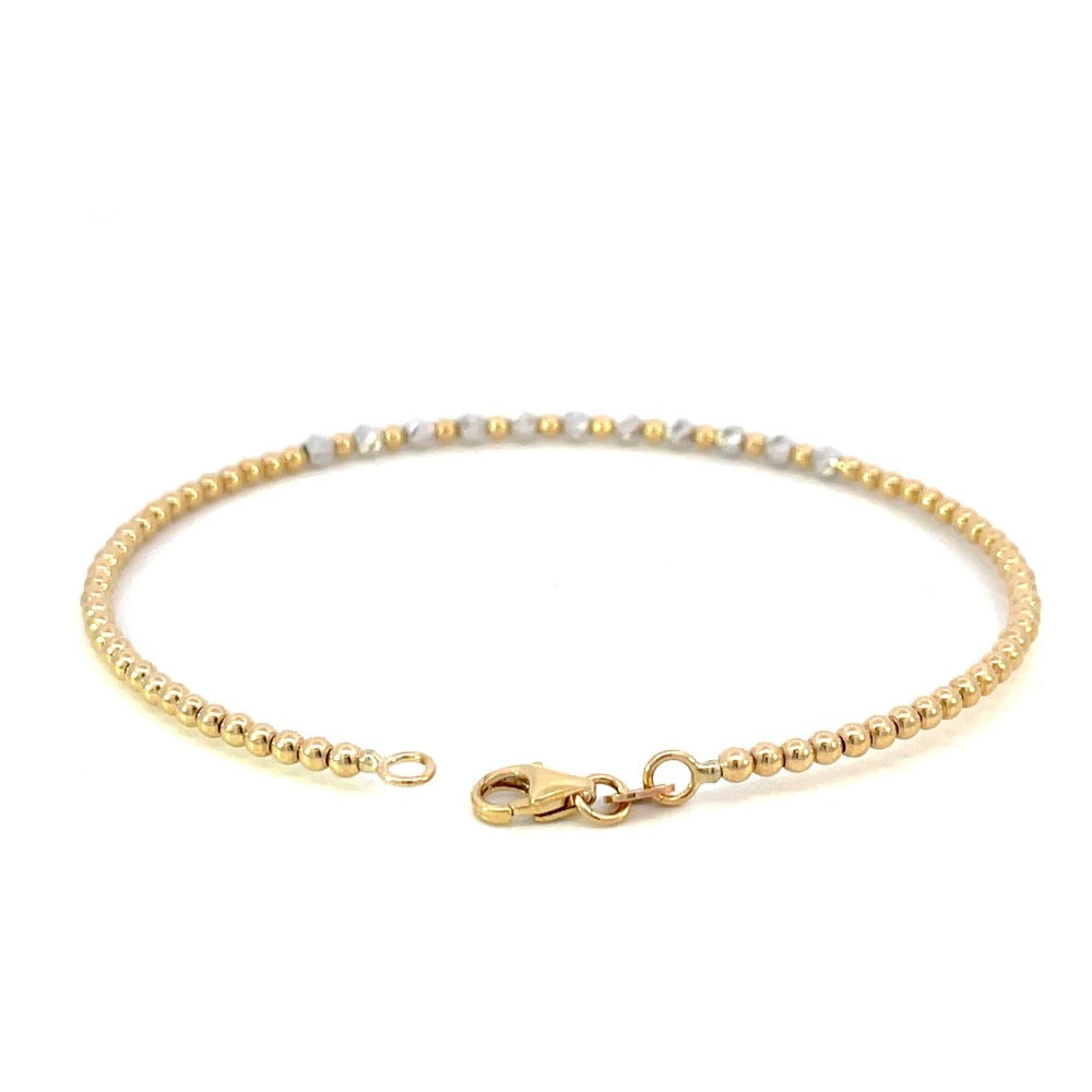 back view of 14k two toned gold beaded bracelet showing the high polish yellow gold beads and lobster clasp