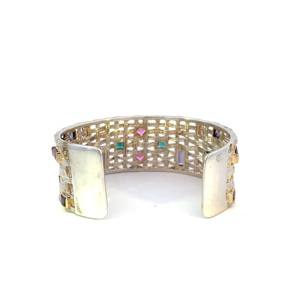 back of sterling silver cuff with yellow gold and colored gem accents