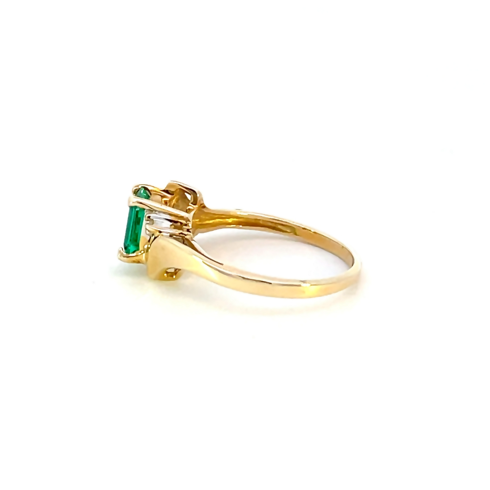 side view of 10 karat yellow gold emerald cut syn. emerald ring with diamond accents