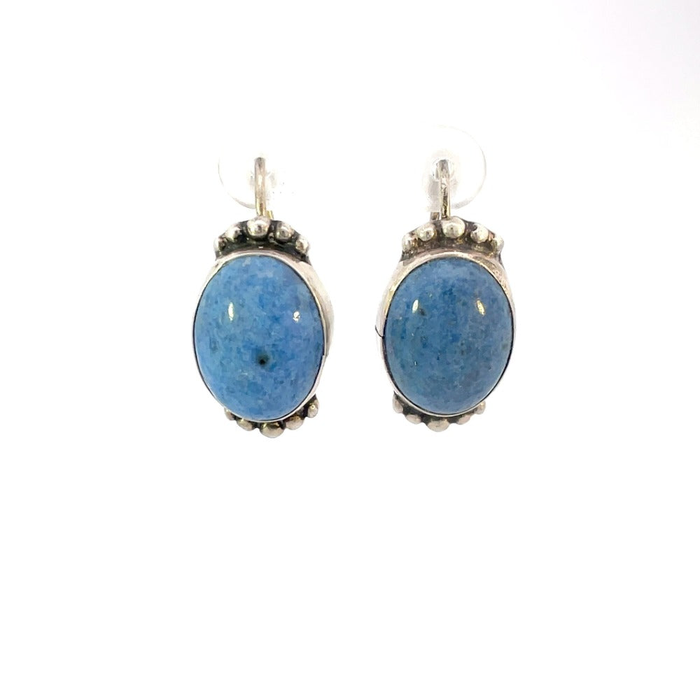 front view of fashion earrings with blue stone and sterling silver bezel settings