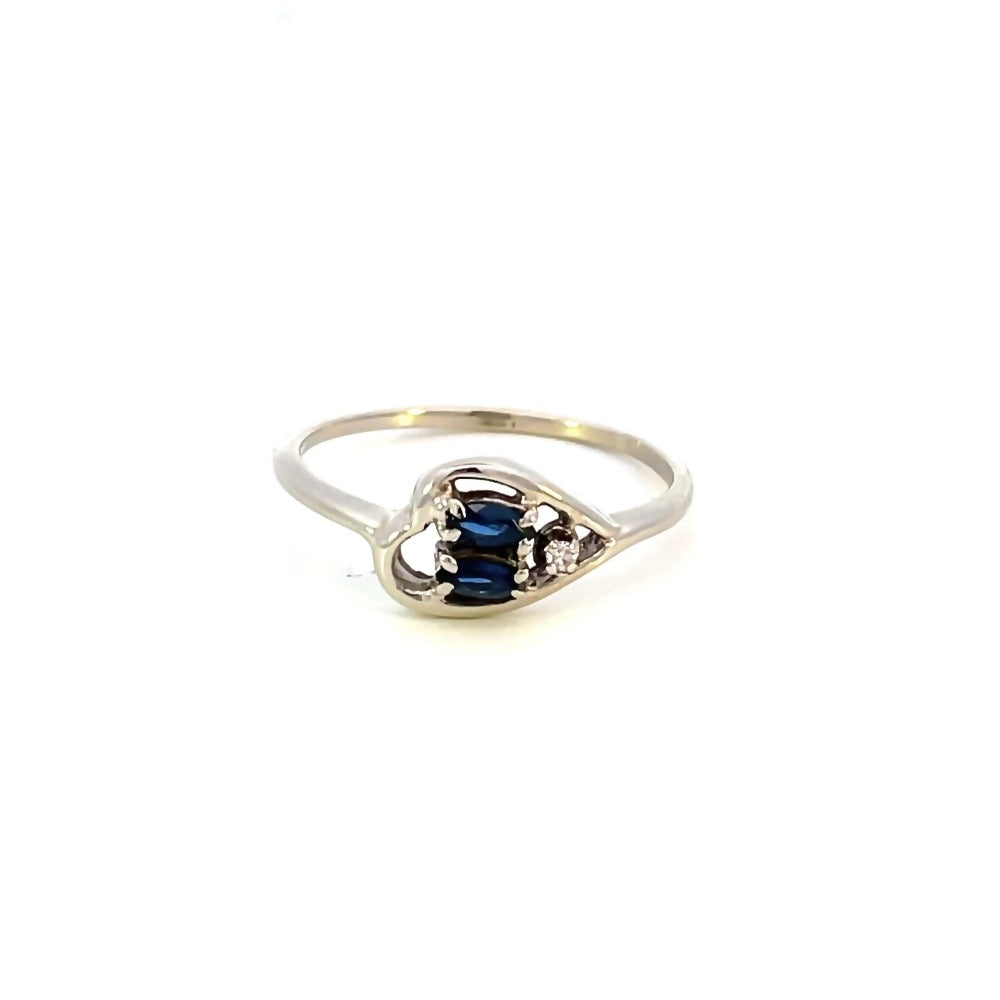 front view of 14kw sideways heart ring with blue sapphires and diamond