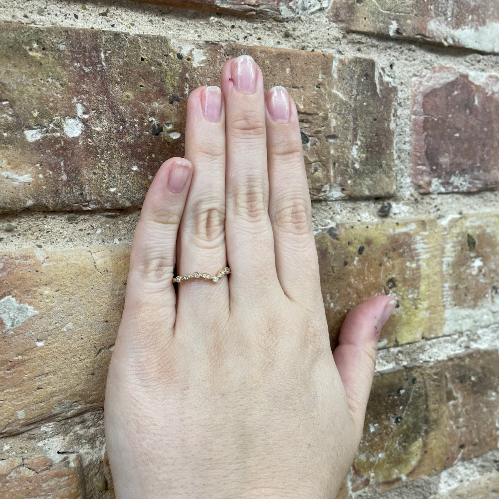 14K Yellow Gold Diamond Contour Wedding Band on hand