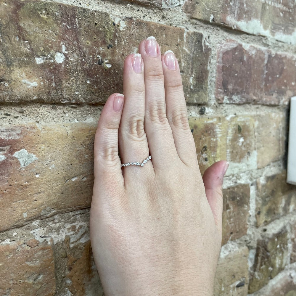 V Shaped Diamond Wedding Band with detailed beading on model's hand