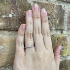 10K Gold and Diamond Curved Wedding Band on model hand
