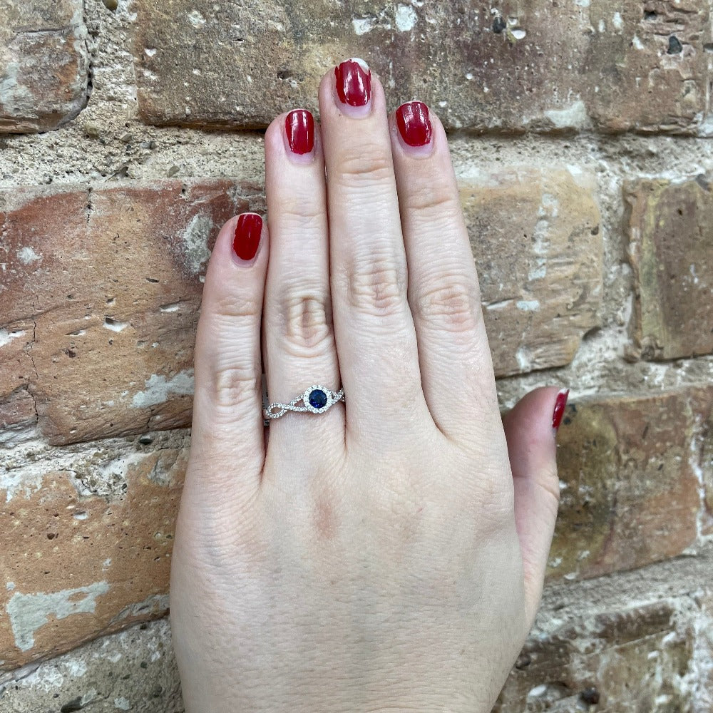 14KW Round Blue Sapphire and Diamond Ring with Halo and Criss Cross Shank on model