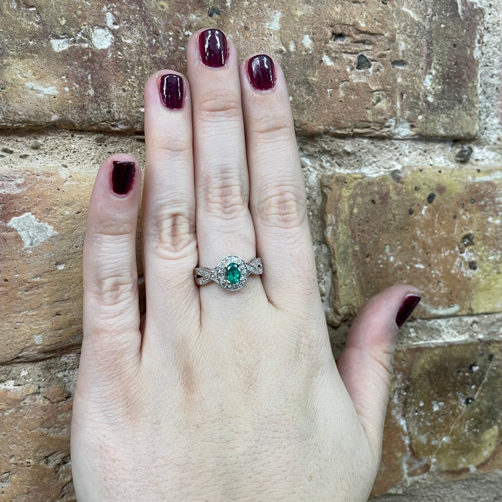 14KW Oval Lab Grown Emerald and Diamond Ring 1/5 CTW on model