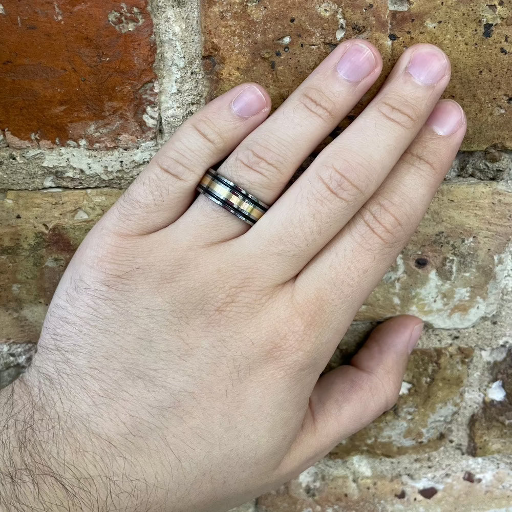 Men's 8mm Tungsten Band with Black Cerakote and 14K Yellow Gold on hand