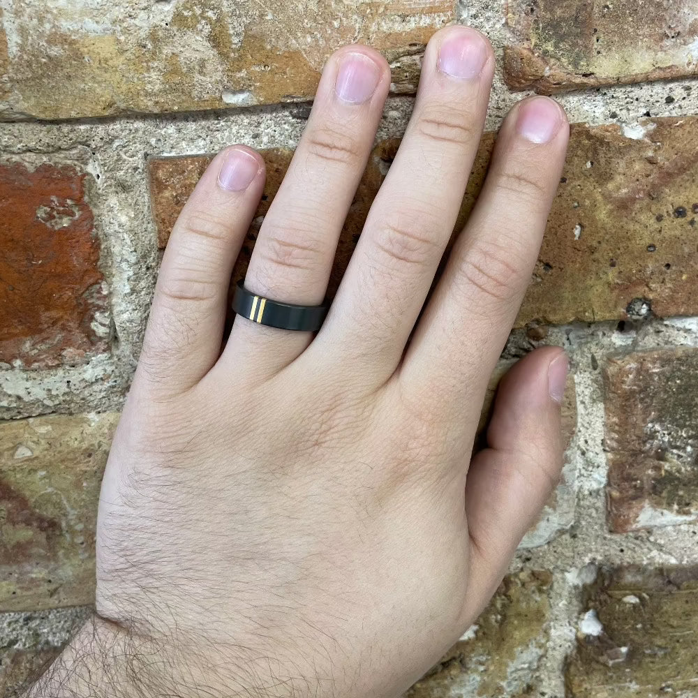 Men's 6mm Black Zirconium Band with Perpendicular Yellow Gold Inlay on hand