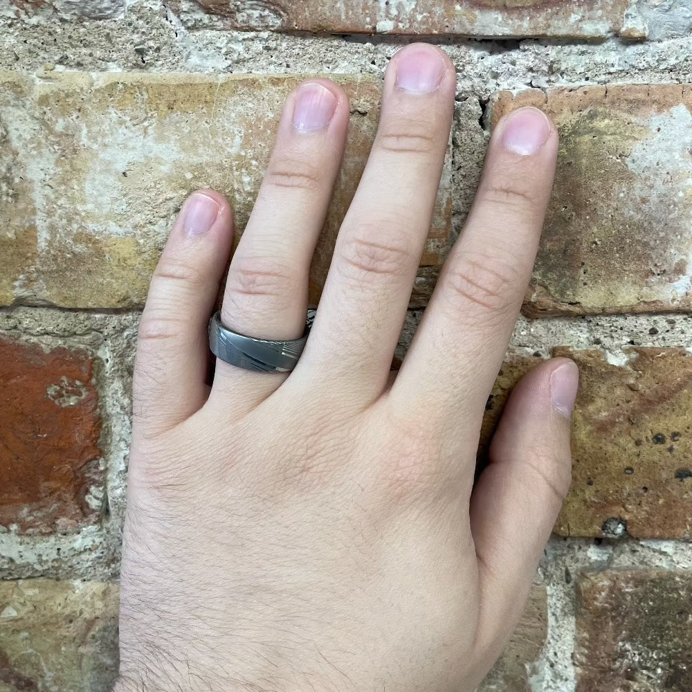 Men's 8mm Twisted Damascus Band with Cocobolo Wood on hand