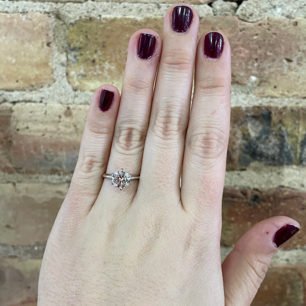 1.60 carat round brilliant cut diamond solitaire engagement ring on the hand of a model
