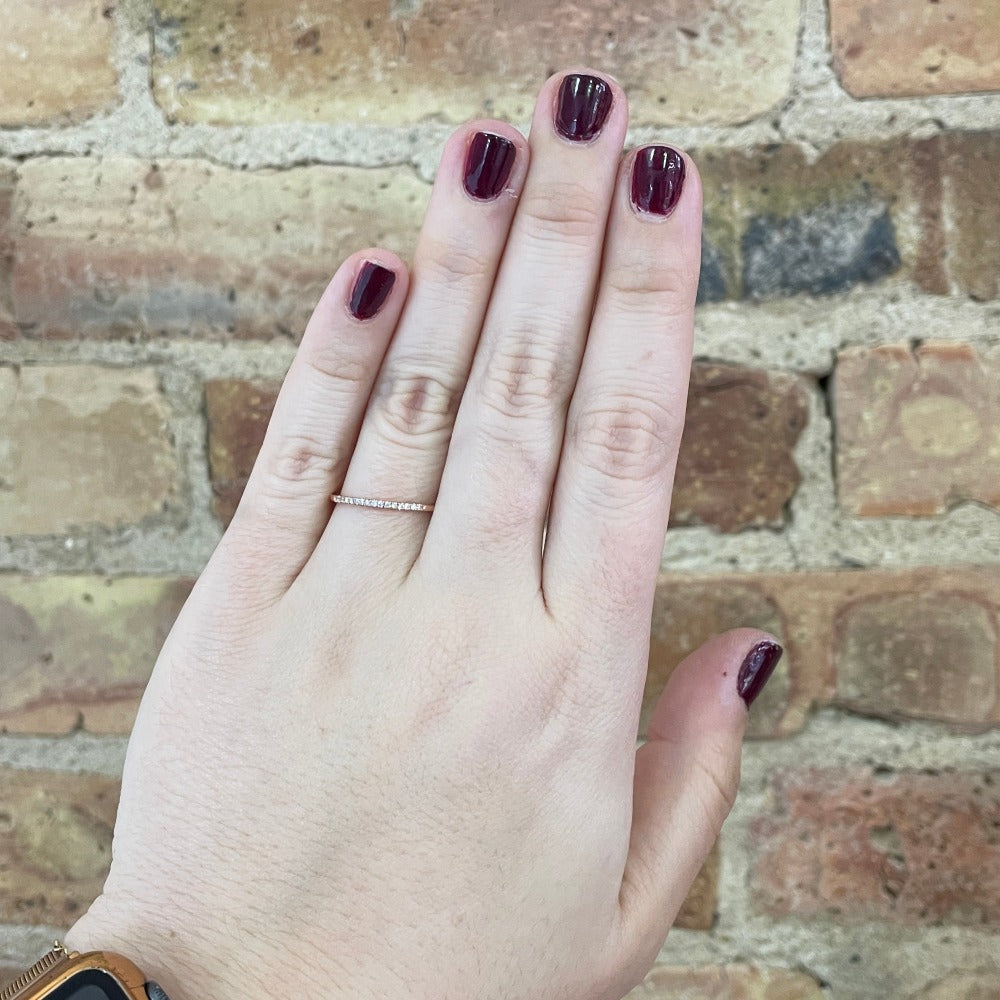 rose gold and diamond band on model's hand