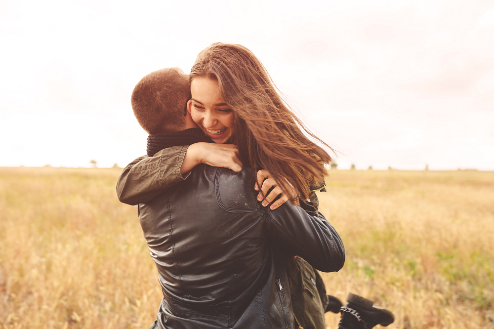 Man and woman happily hugging