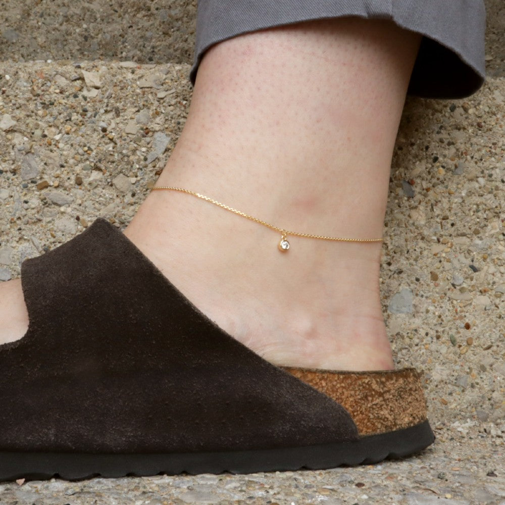 Gold Ankle Bracelet with Diamond Charm on a model