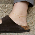 Gold Ankle Bracelet with Diamond Charm on a model