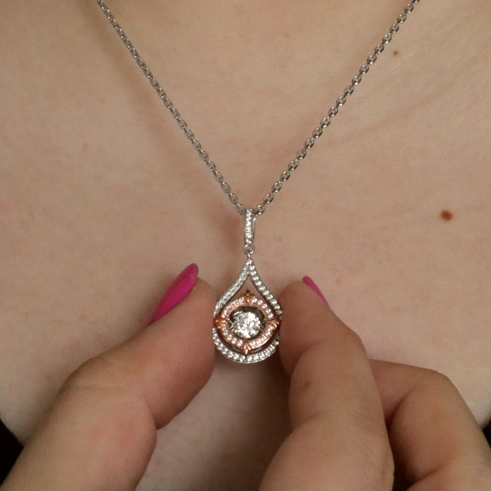 Sterling Silver & CZ Two-Toned Rhythm of Love Fleur-de-Lis Drop Pendant on model close up