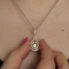 Sterling Silver & CZ Two-Toned Rhythm of Love Fleur-de-Lis Drop Pendant on model close up