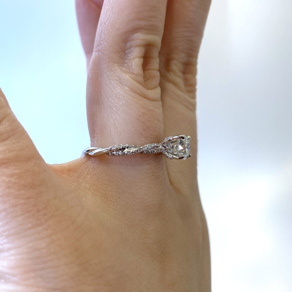 side view of engagement ring showing diamond shank and diamonds on head. 