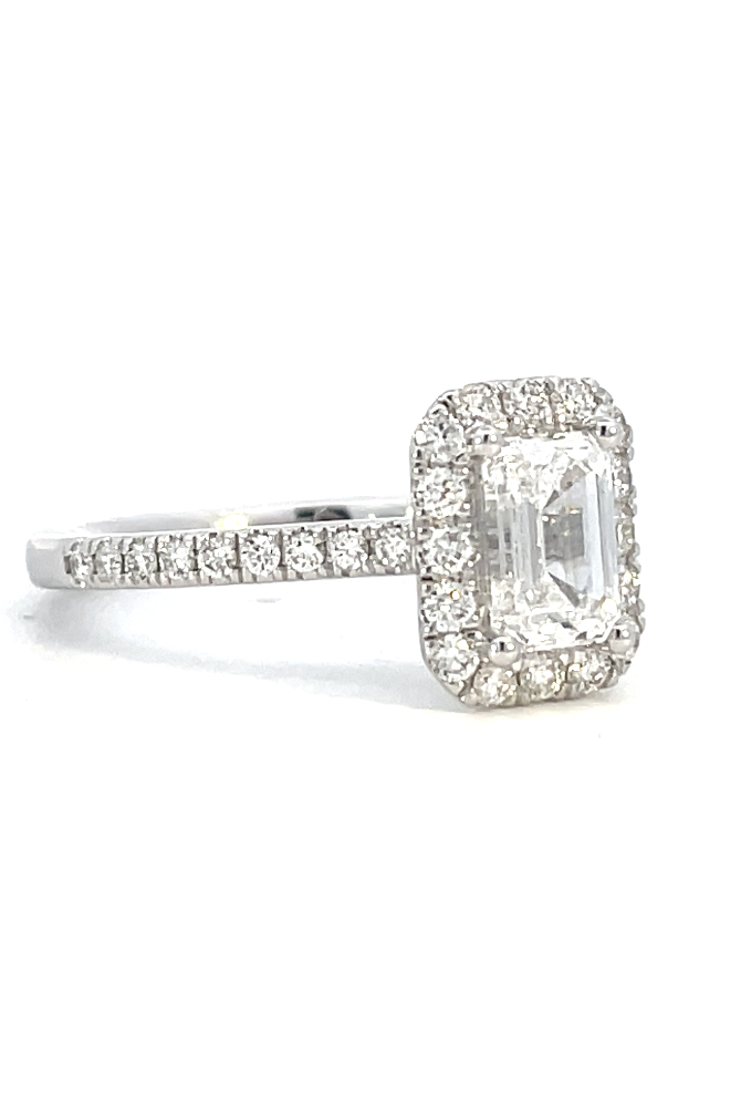 side view of emerald cut lab grown diamond halo style engagement ring.