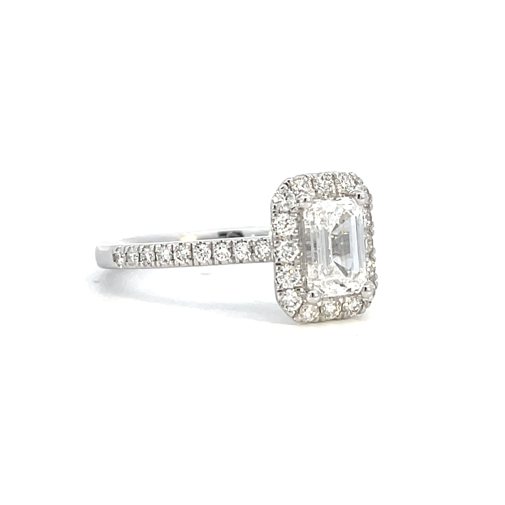 side view of emerald cut lab grown diamond halo style engagement ring.