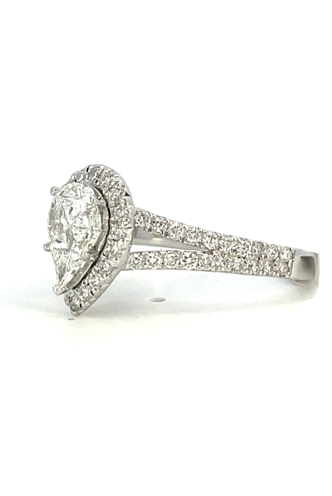 side profile view of 14kw pear shaped halo style engagement ring with split shank.