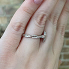 side view of 14kw marquise halo style ring with twisted shank on model