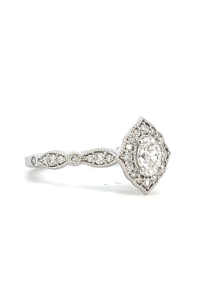side view of vintage inspired halo style engagement ring with oval center stone