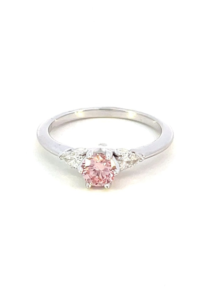 front view of pink diamond engagement ring with pear accents