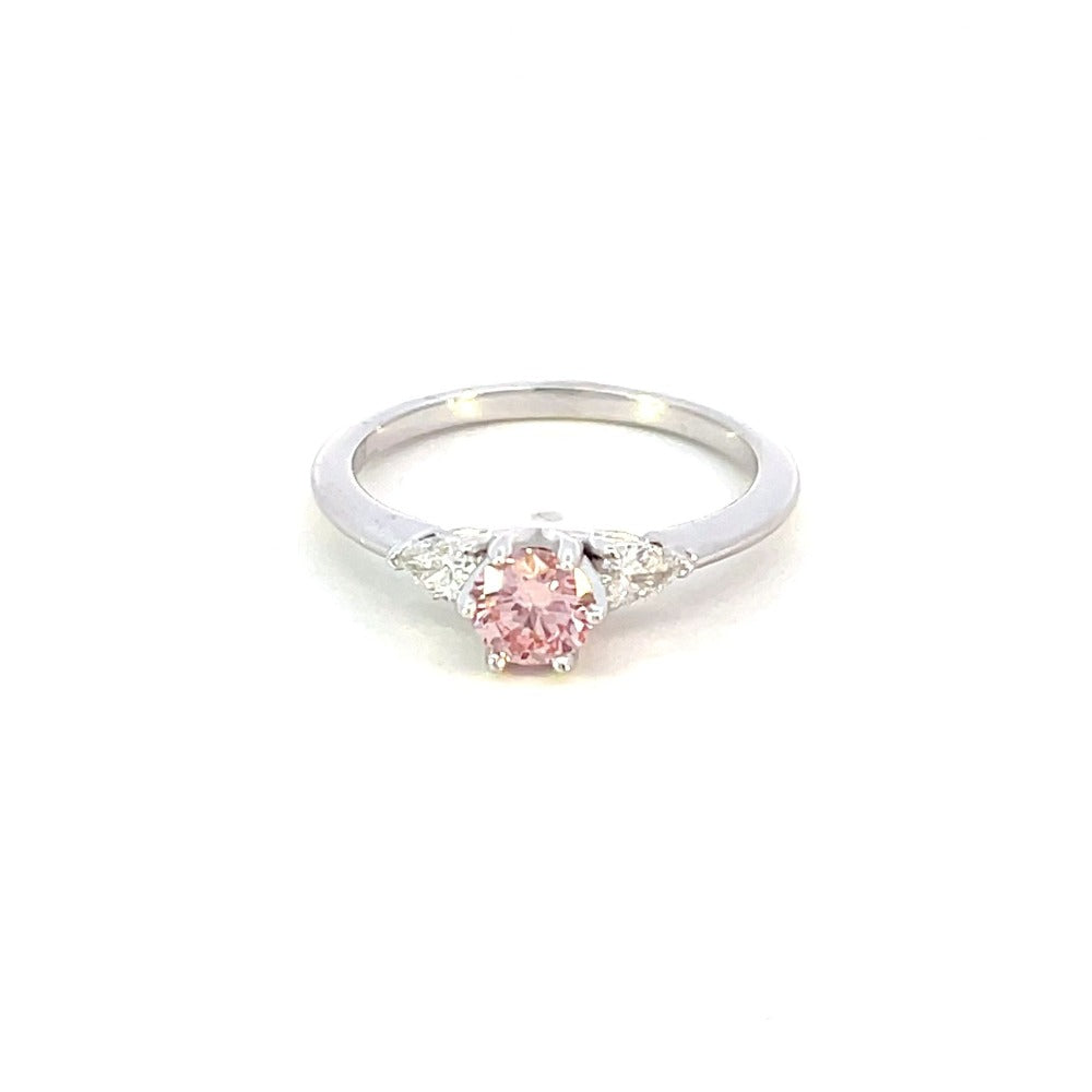 front view of pink diamond engagement ring with pear accents