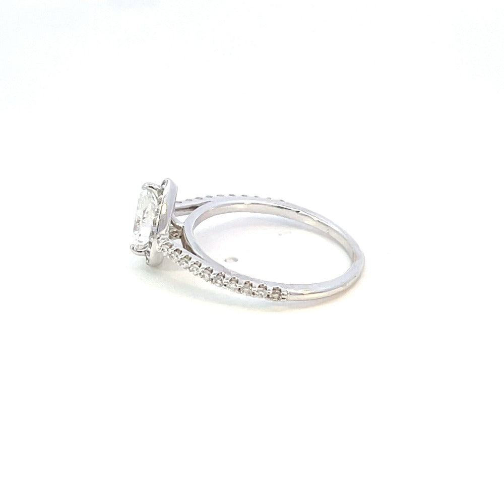 side view of 14kw diamond engagement ring with halo and pear cut center
