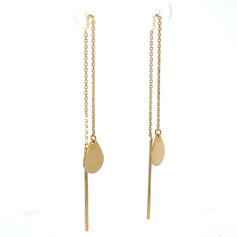 Detail view of 14k yellow gold threader earrings with pear-shaped drop