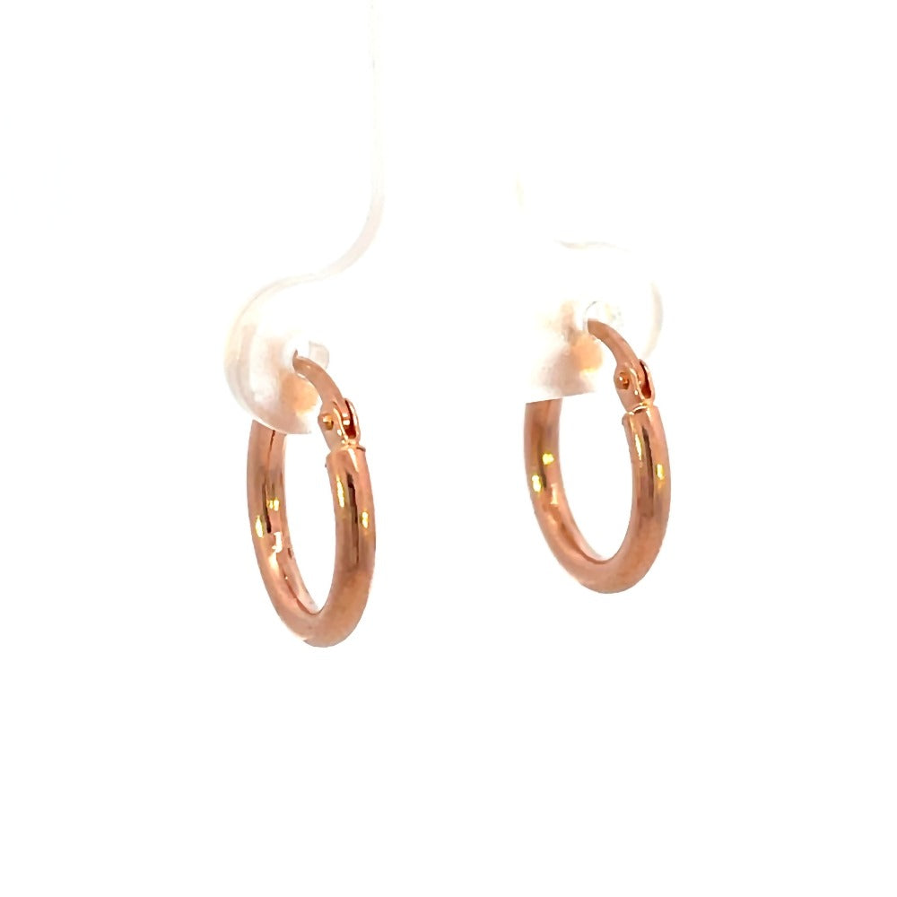 View of 14K rose gold hoops that shows thickness of metal