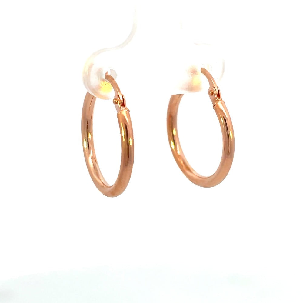 View of 15mm 14K rose gold hoop earrings that shows the thickness of the metal.