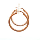 side view of 20mm 14k rose gold hoop earrings that shows the side of the earrings as well as a the closure.