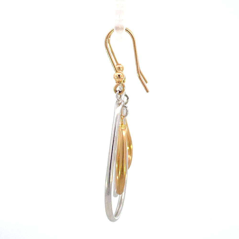 side view of 14k two toned gold earrings with pear shaped drops and French wires