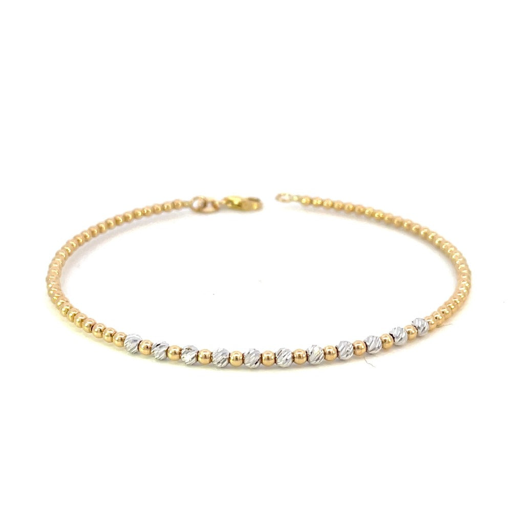 front view of 14k gold two-toned beaded bracelet showing the alternating pattern of yellow and white gold beads