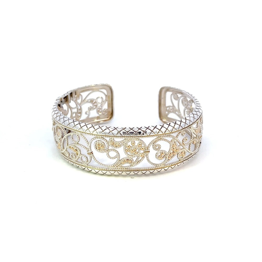 front view of sterling silver filigree design cuff with yellow gold accents