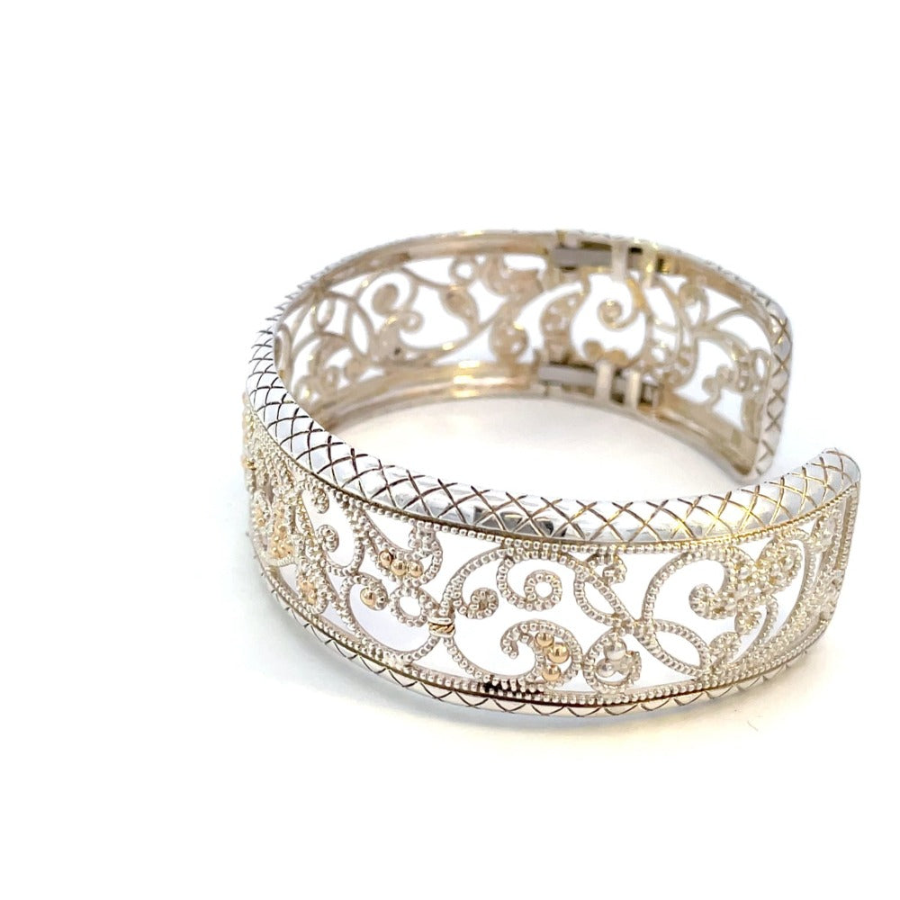 side view of sterling silver cuff with yellow gold accents and filigree design