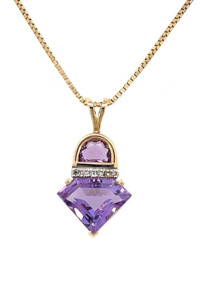 detail view of yellow gold amethyst pendant with diamond accents on a box chain