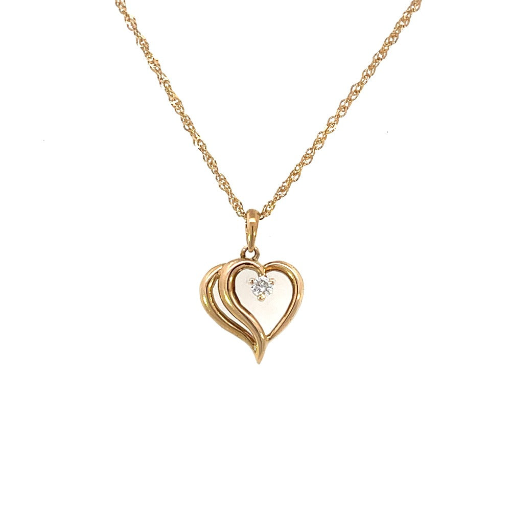 detail view of heart shaped pendant with diamond accent