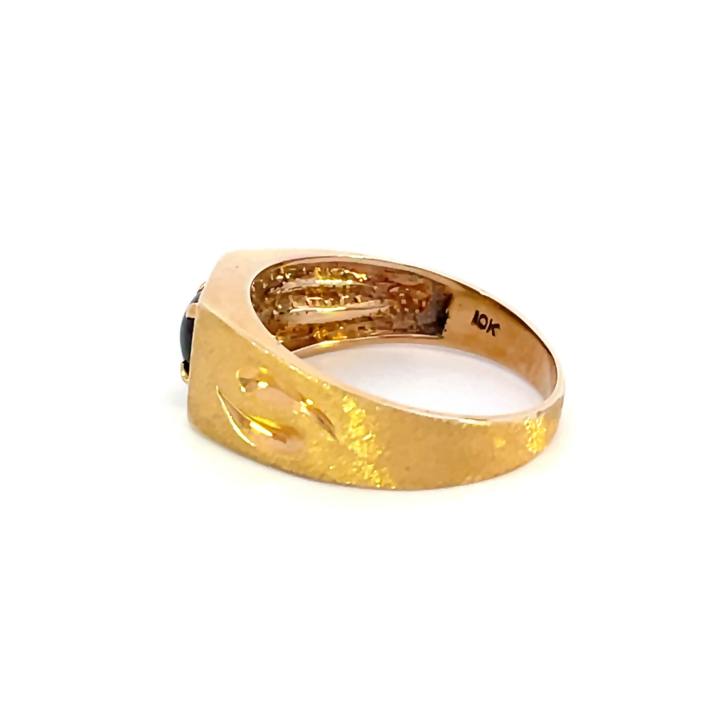 side view of gents 10 karat yellow gold ring with black star sapphire center stone. picture shows the 10k gold stamp on the inside of the band.