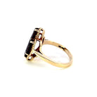 side view of 10ky marquise garnet ring that shows 10k stamp